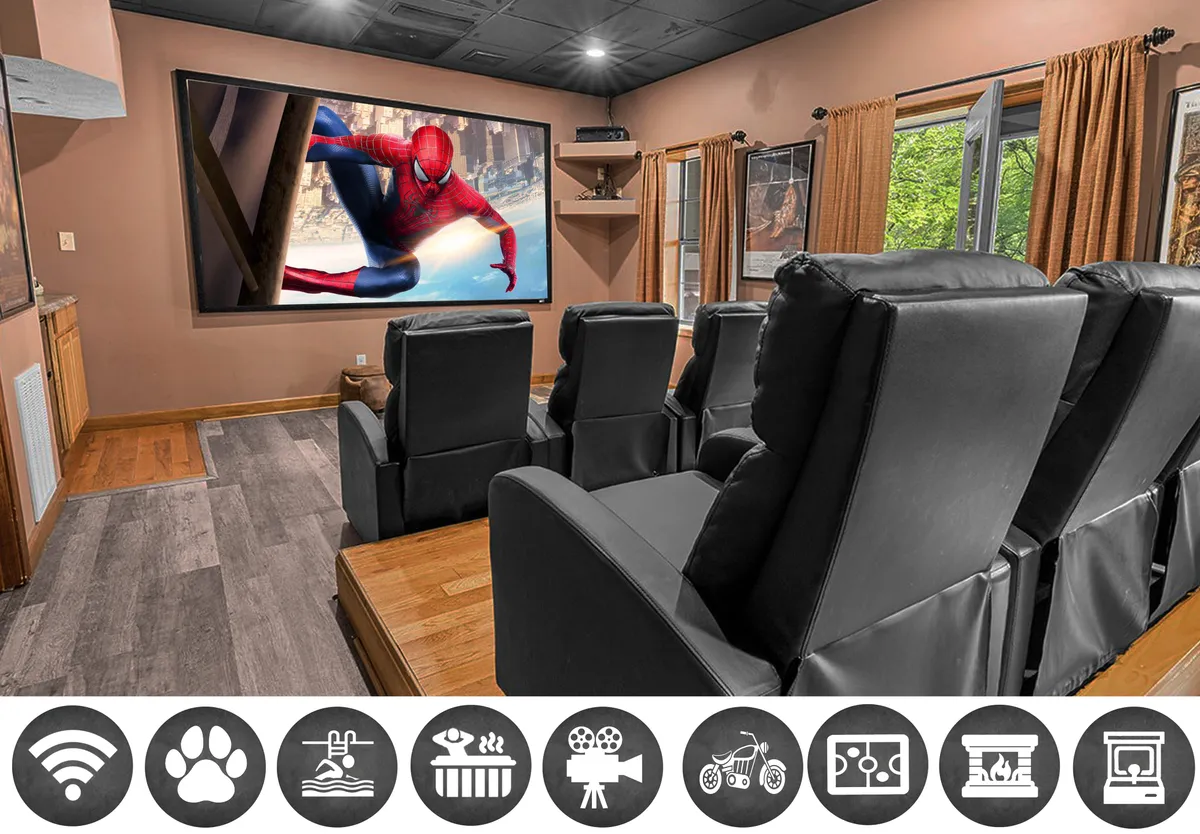 The image showcases a cozy home theater setup, featuring plush black recliners arranged in front of a large screen displaying Spider-Man. The room is accented with warm wooden flooring and soft curtains, creating an inviting space perfect for movie nights and family gatherings.